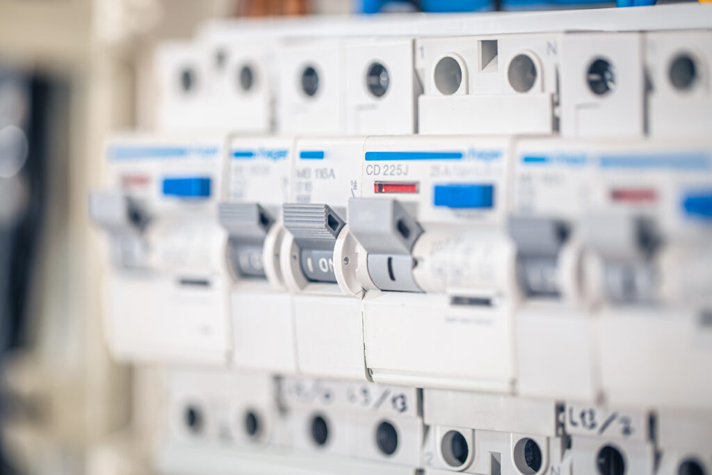 Voltage distributor with automatic switches. Electrical background.