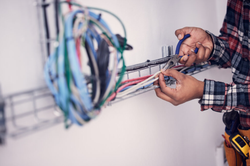 hands of man with cable maintenance, inspection and home repair