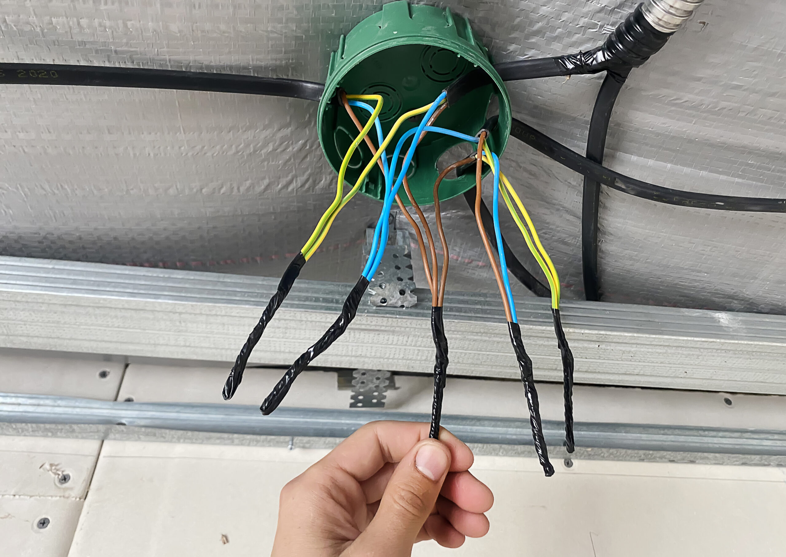 Electrical wiring of the junction box, installation, twisting of the box by an electrician. 